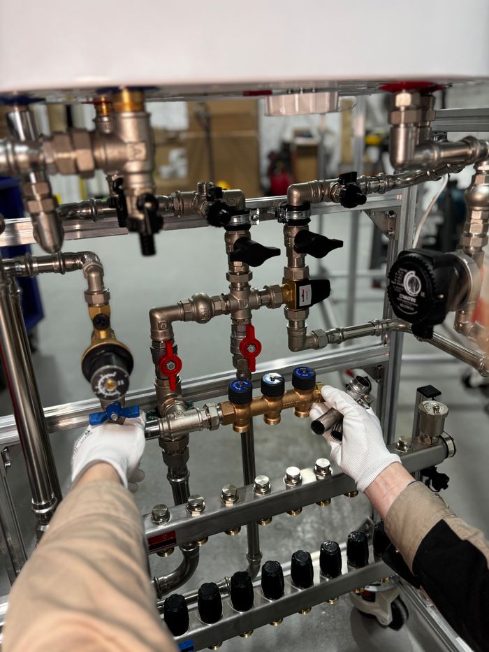 gallery-3 Engineer adjusting metal pipeline valves in an industrial setting with precision.