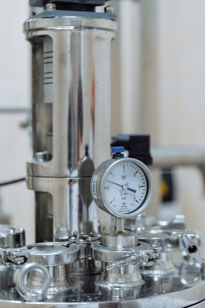 services-img Detailed view of a stainless steel pressure gauge in a laboratory or industrial setting.